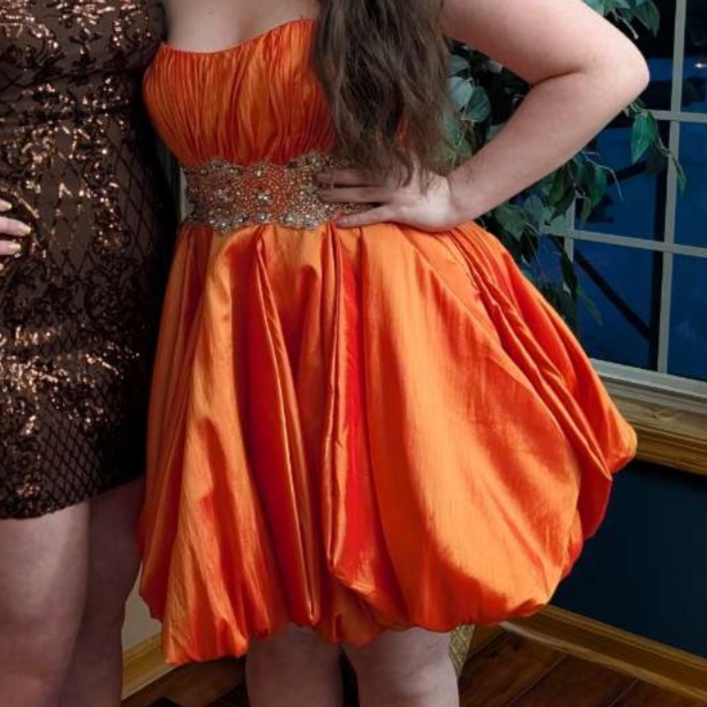 Orange Maggie Sottero formal dress.